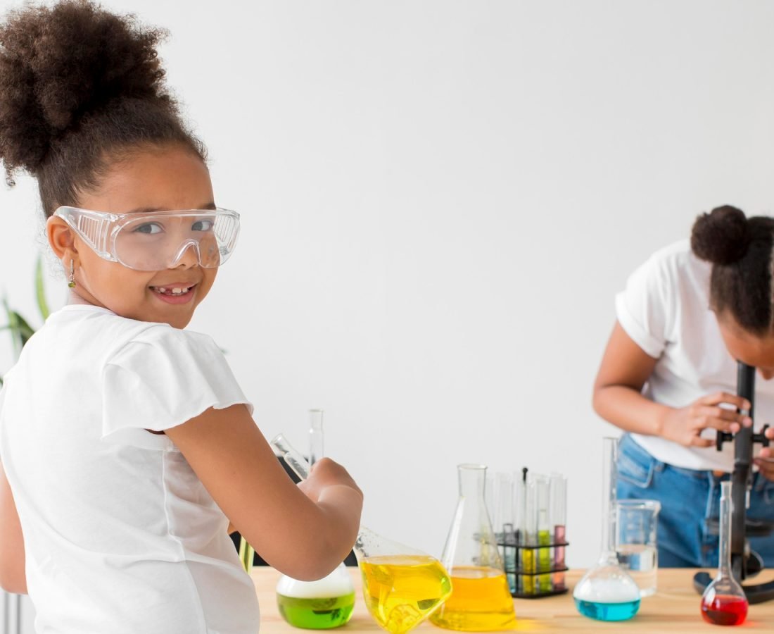 two-girls-with-safety-glasses-experimenting-with-chemistry-potions